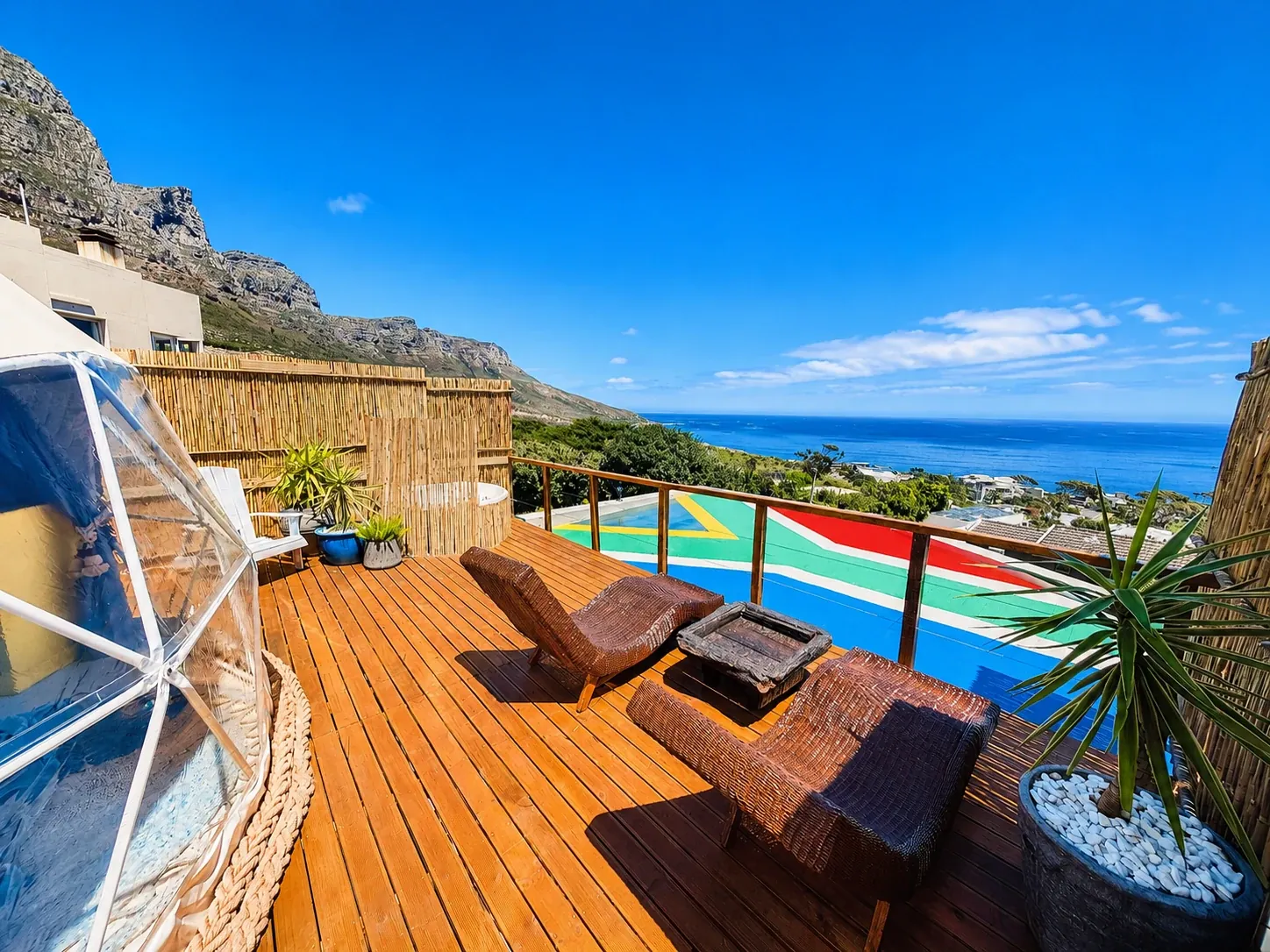 Geodesic dome on a timber deck above the sea